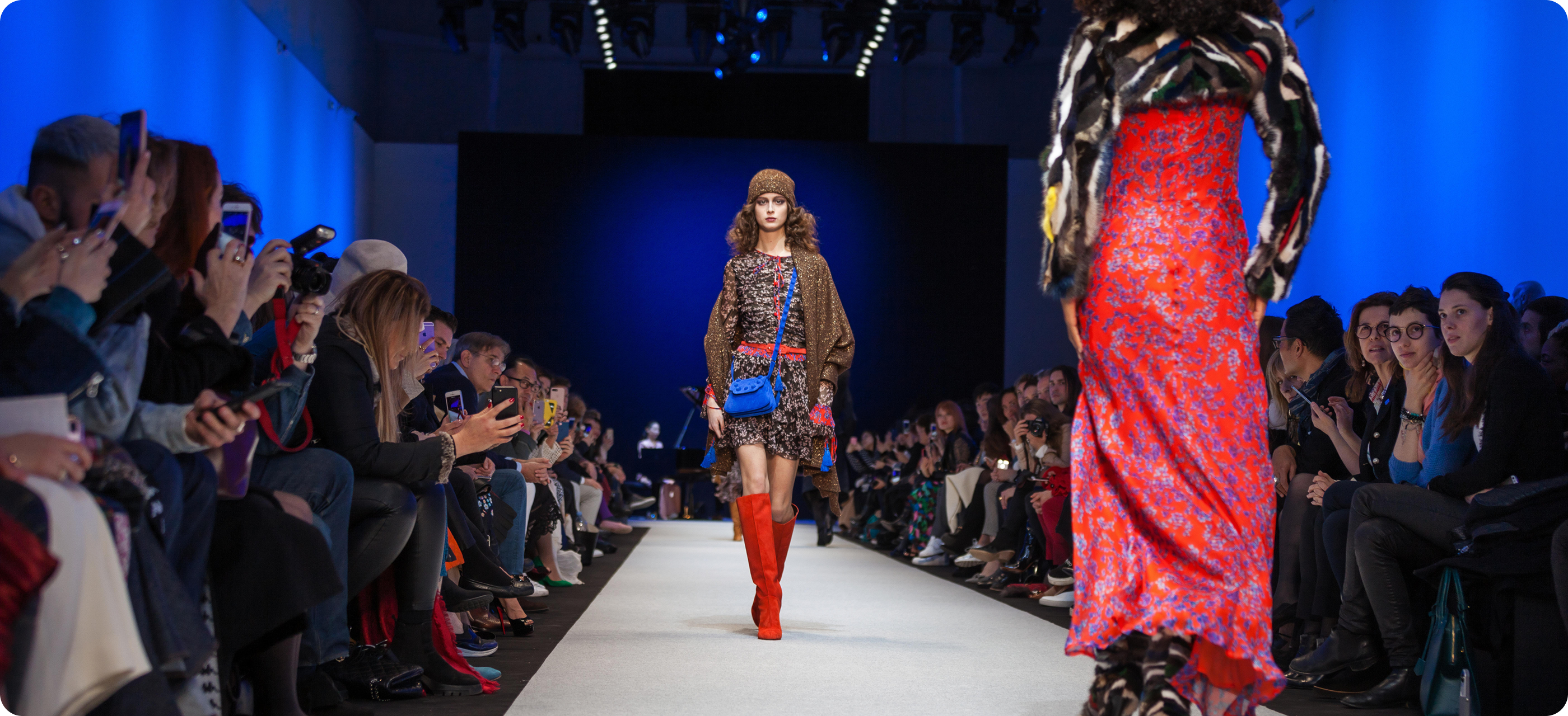 Fashion runway presentation with models and an audience